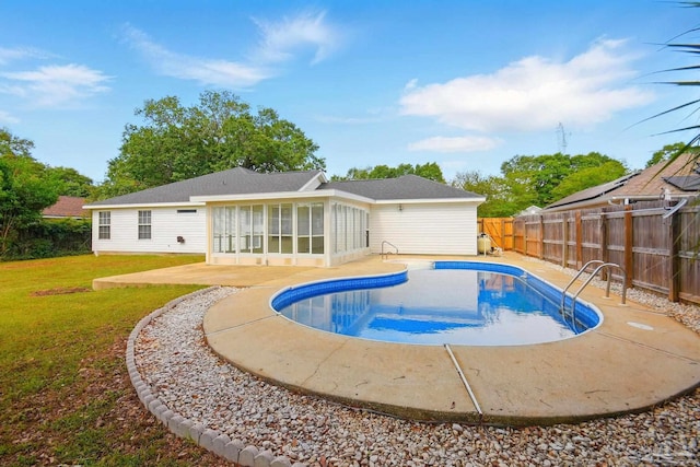 view of pool with a sunroom, a fenced backyard, a fenced in pool, a patio area, and a yard