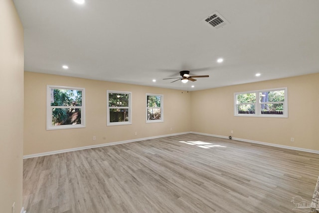 empty room featuring light hardwood / wood-style floors, plenty of natural light, and ceiling fan