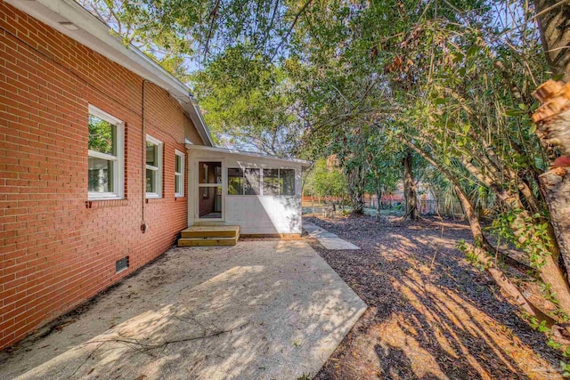 view of patio featuring a sunroom