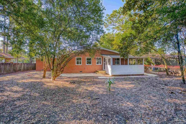 rear view of property with a sunroom