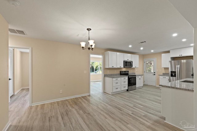 kitchen with light stone countertops, white cabinetry, hanging light fixtures, stainless steel appliances, and light wood-type flooring