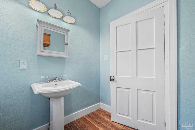 bathroom with wood-type flooring and sink