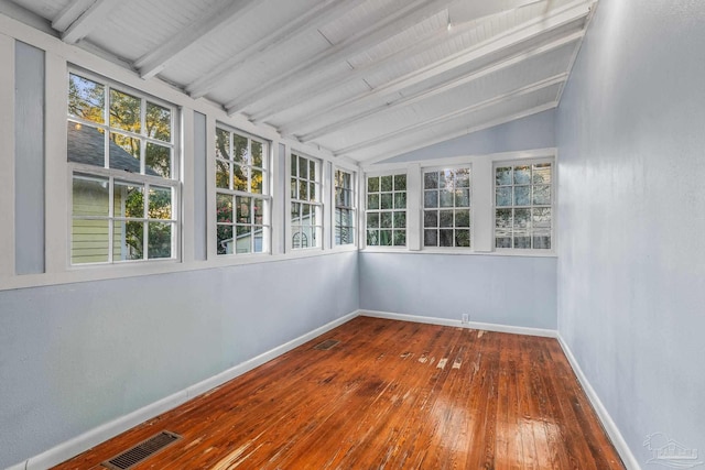 unfurnished sunroom with lofted ceiling with beams