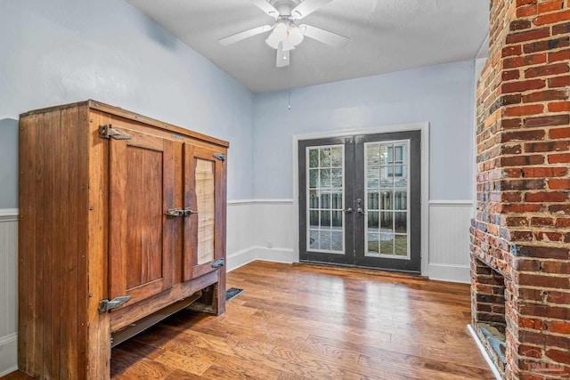 interior space with hardwood / wood-style floors, french doors, and ceiling fan