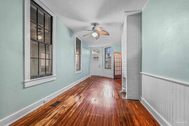 spare room featuring dark wood-type flooring, ornamental molding, and ceiling fan