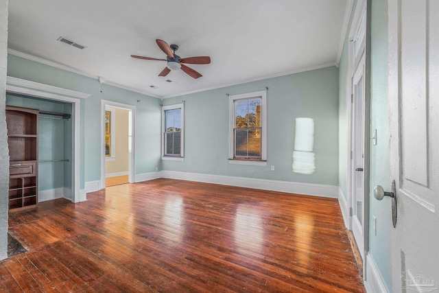 unfurnished bedroom featuring dark wood-type flooring, ceiling fan, ornamental molding, and connected bathroom