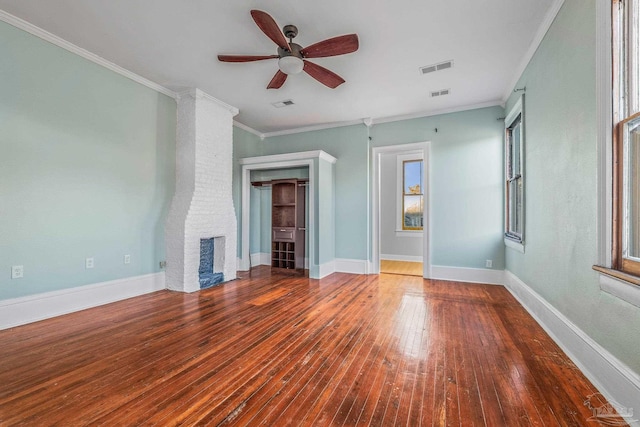 unfurnished living room featuring hardwood / wood-style flooring, ornamental molding, ceiling fan, and a fireplace