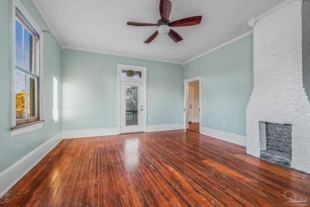 unfurnished living room with dark hardwood / wood-style flooring, crown molding, a fireplace, and plenty of natural light