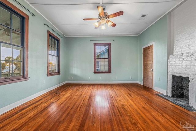 unfurnished living room featuring ceiling fan, wood-type flooring, and a fireplace