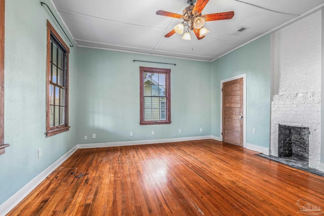 unfurnished living room featuring ceiling fan, a fireplace, and hardwood / wood-style floors