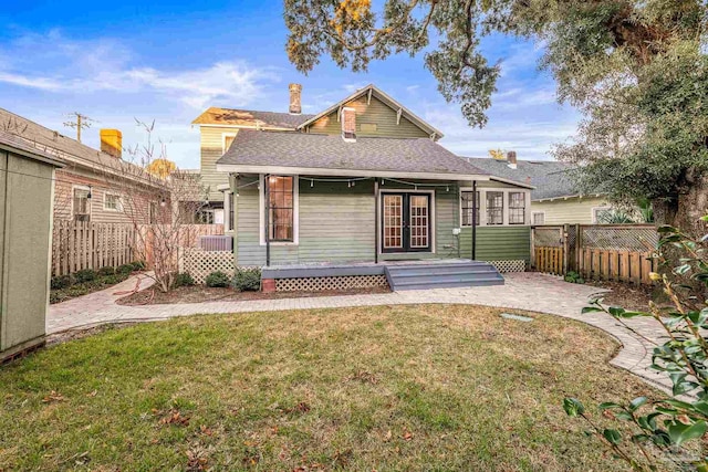 rear view of house with a lawn