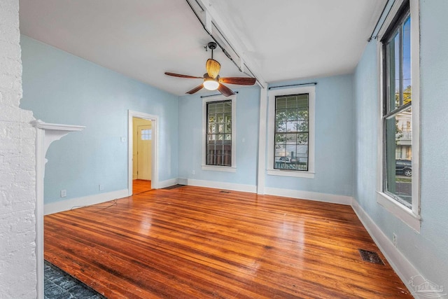 spare room with wood-type flooring and ceiling fan