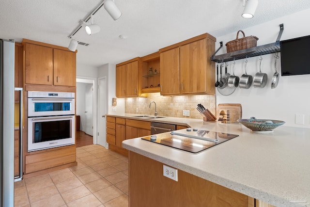 kitchen featuring white double oven, open shelves, light countertops, a sink, and a peninsula