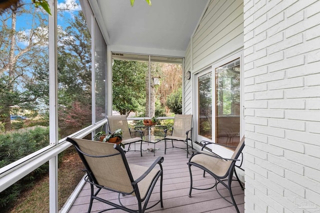 sunroom / solarium featuring lofted ceiling