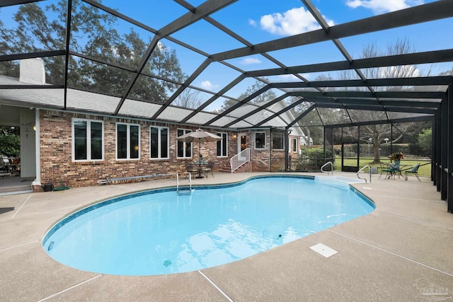 pool with a patio area and a lanai