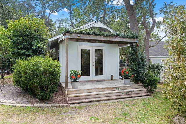 view of outbuilding with fence, french doors, and an outdoor structure