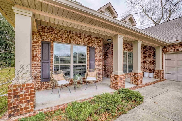 view of patio / terrace featuring covered porch and an attached garage