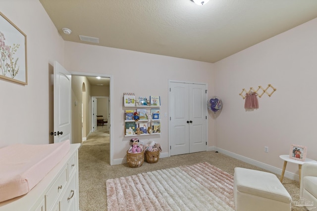 recreation room featuring visible vents, light colored carpet, a textured ceiling, and baseboards