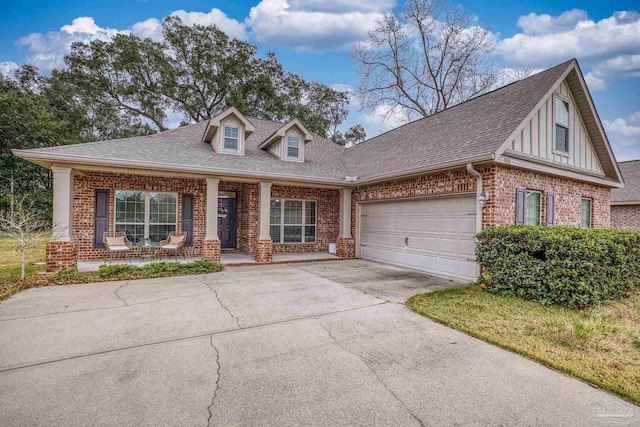 view of front of home featuring concrete driveway, brick siding, roof with shingles, and a porch