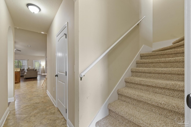 stairway featuring baseboards