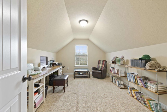 office featuring lofted ceiling, a textured ceiling, baseboards, and carpet flooring