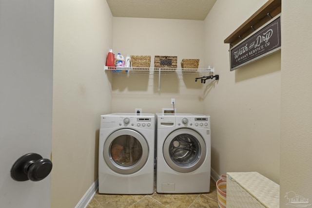 clothes washing area with laundry area, independent washer and dryer, and baseboards