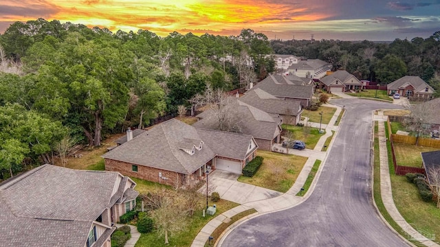 aerial view at dusk featuring a residential view