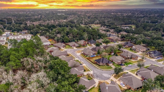 aerial view at dusk featuring a residential view