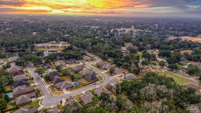 aerial view at dusk featuring a residential view