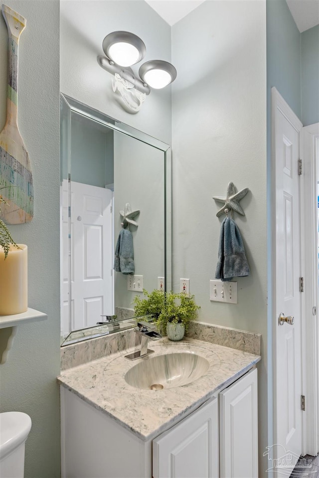 bathroom with toilet and vanity