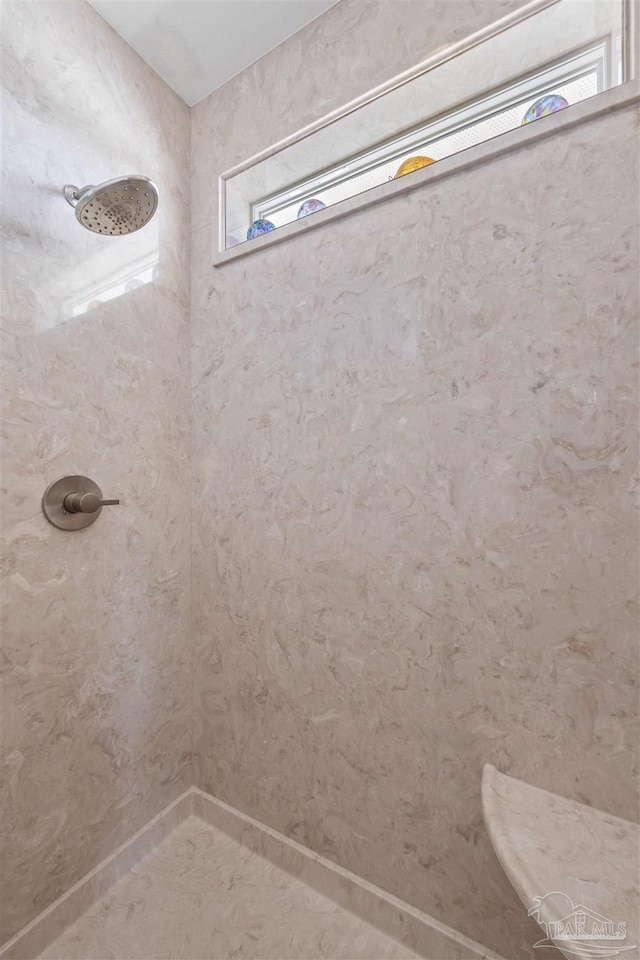 bathroom featuring a tile shower
