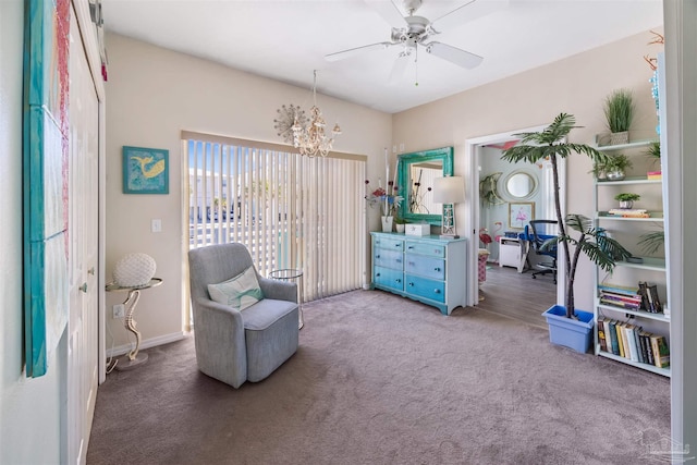 living area with ceiling fan with notable chandelier and carpet floors