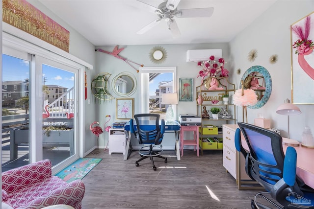 home office with dark wood finished floors, baseboards, a wall mounted AC, and ceiling fan
