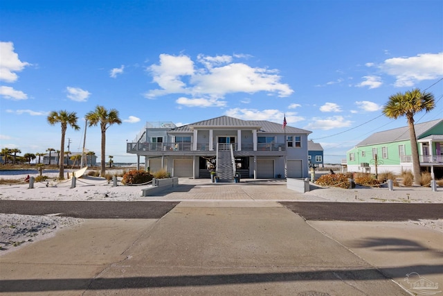 view of front of property with driveway, a garage, and metal roof