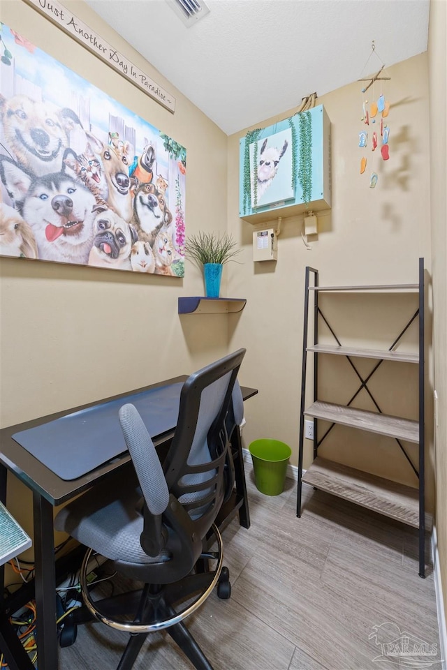 office area with baseboards and wood finished floors