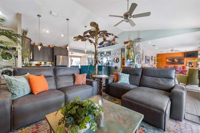 living area featuring visible vents, wood finished floors, vaulted ceiling, and a ceiling fan