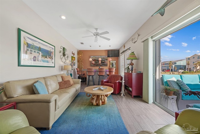 living room featuring light wood-style flooring, ceiling fan, and recessed lighting