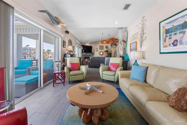 living room featuring wood finished floors, recessed lighting, vaulted ceiling, and visible vents