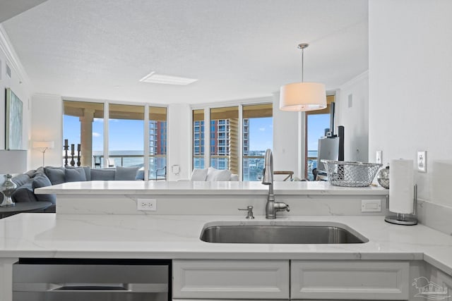 kitchen featuring sink, white cabinets, a textured ceiling, and light stone countertops