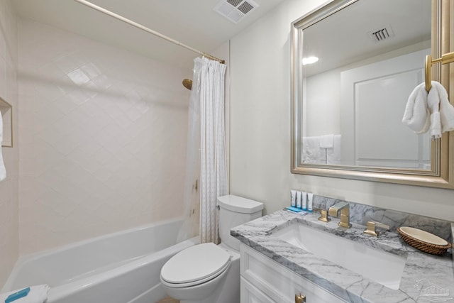 full bathroom with shower / tub combo with curtain, vanity, and toilet