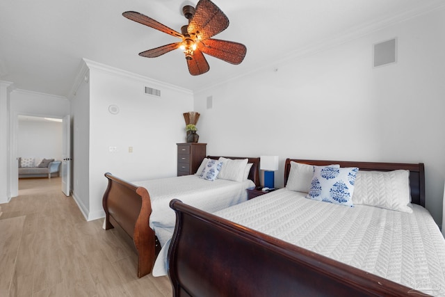 bedroom with ceiling fan, light hardwood / wood-style flooring, and crown molding