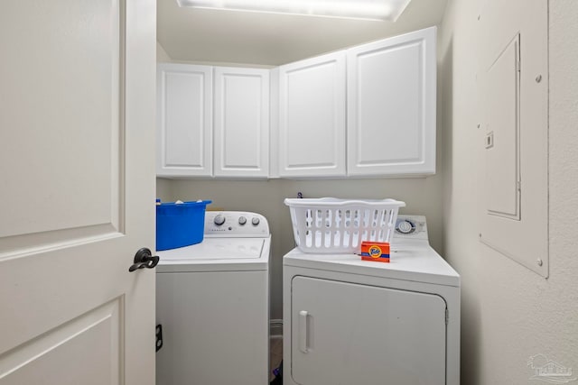 washroom featuring cabinets and separate washer and dryer