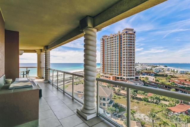 balcony featuring a beach view and a water view