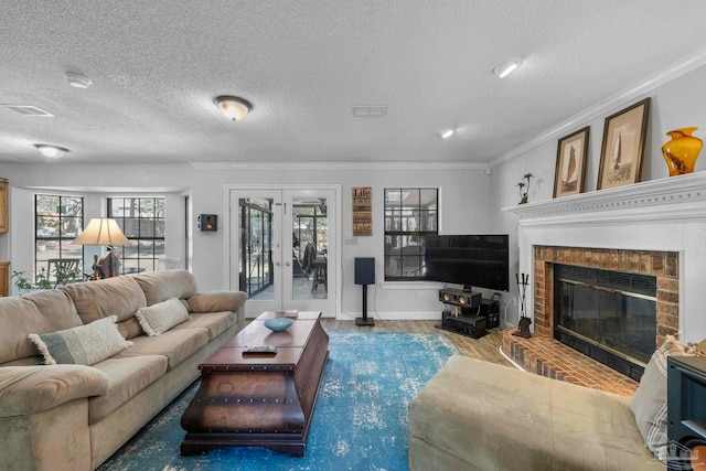 living area with ornamental molding, wood finished floors, a textured ceiling, french doors, and a fireplace