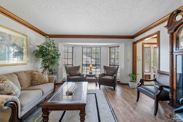 living area featuring a textured ceiling, wood finished floors, and crown molding