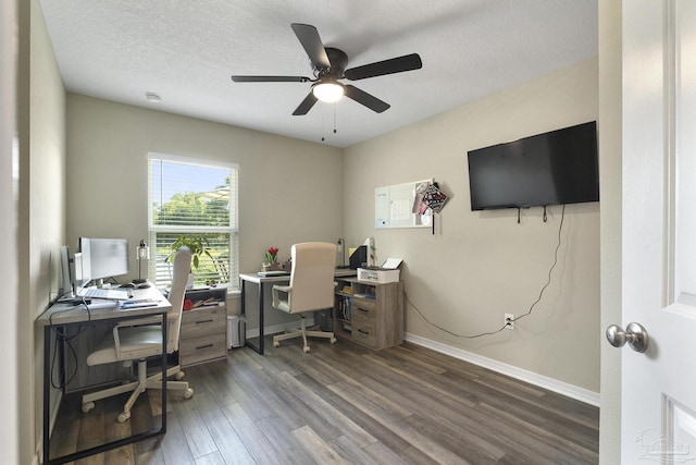 home office featuring dark wood finished floors, a textured ceiling, and baseboards