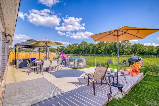 view of patio / terrace with a fenced backyard, a fenced in pool, and a gazebo