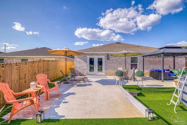 view of patio / terrace with a gazebo, french doors, fence, and an outdoor living space