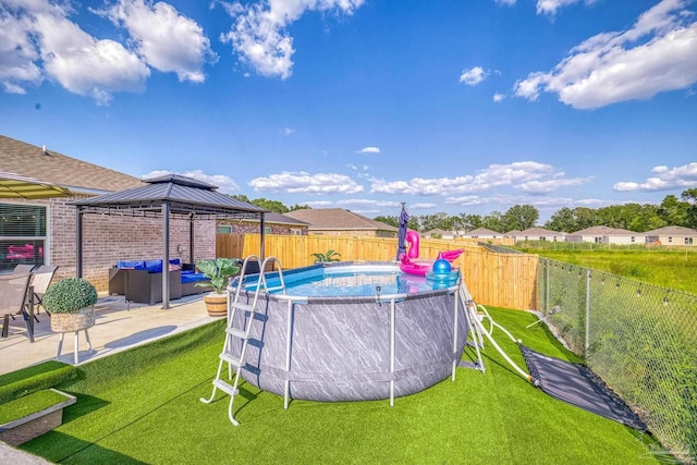 view of swimming pool with a fenced in pool, a fenced backyard, a gazebo, a yard, and outdoor lounge area