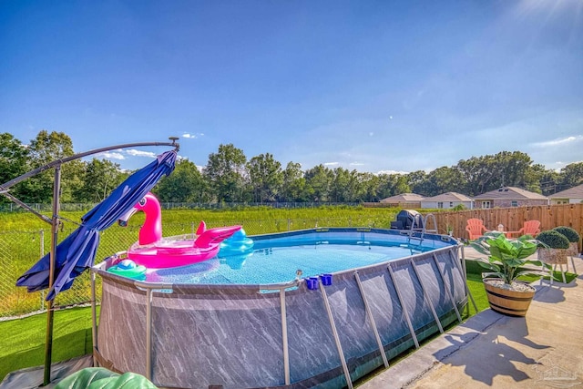 view of pool featuring a lawn